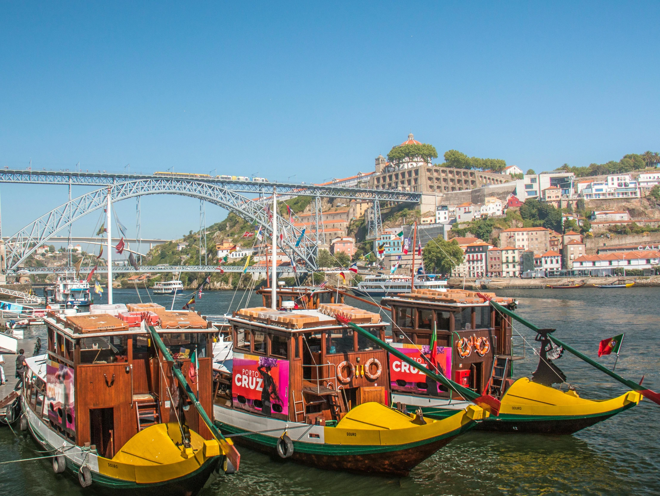 many small wooden boats docked on the water