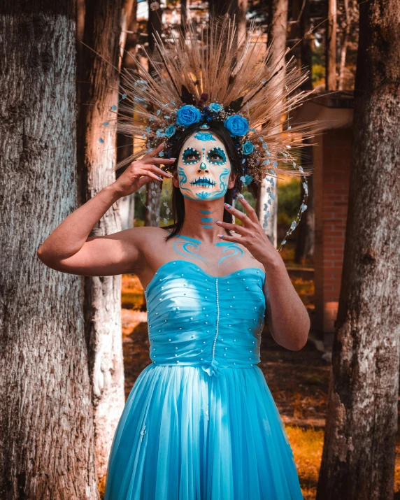 woman in blue dress with face paint on outside