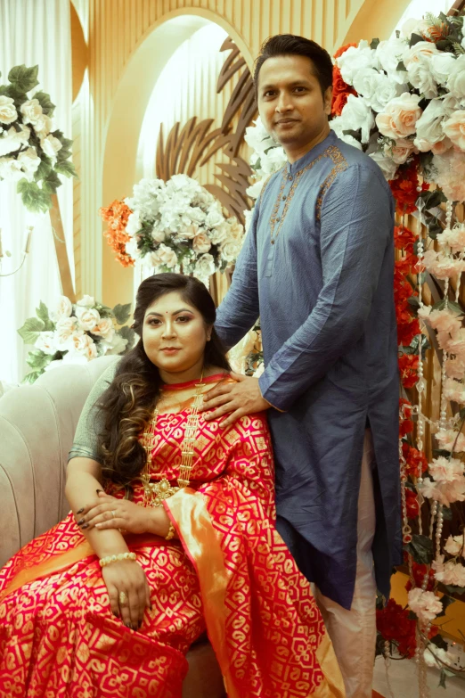 two people pose for the camera during their hindu ceremony