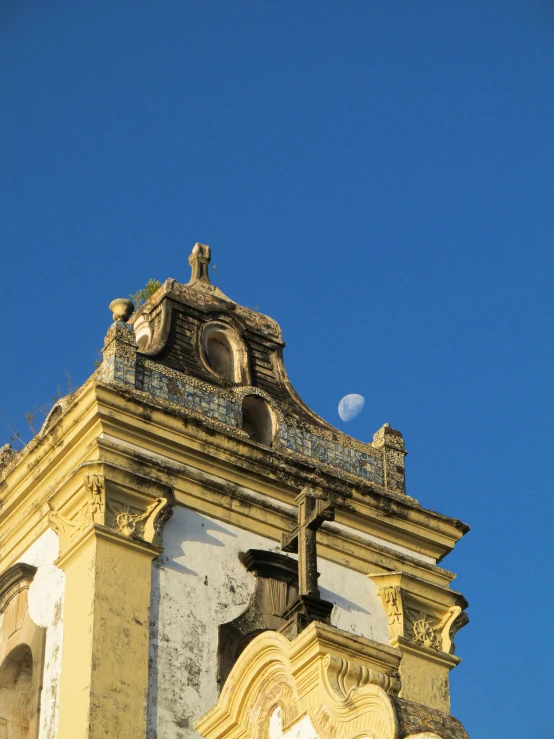 a large clock tower sitting under a blue sky