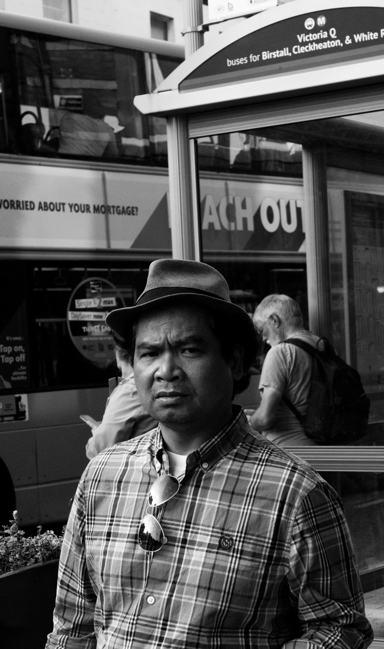 a man standing on a city street with a tie on