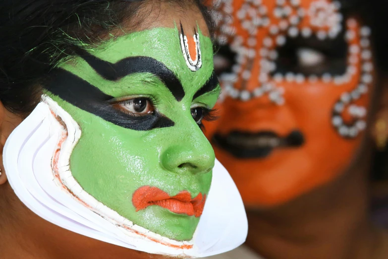 two young people with colorful make up and face paint