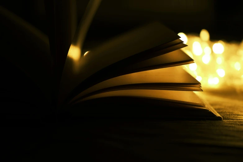 an open book sitting on top of a wooden table