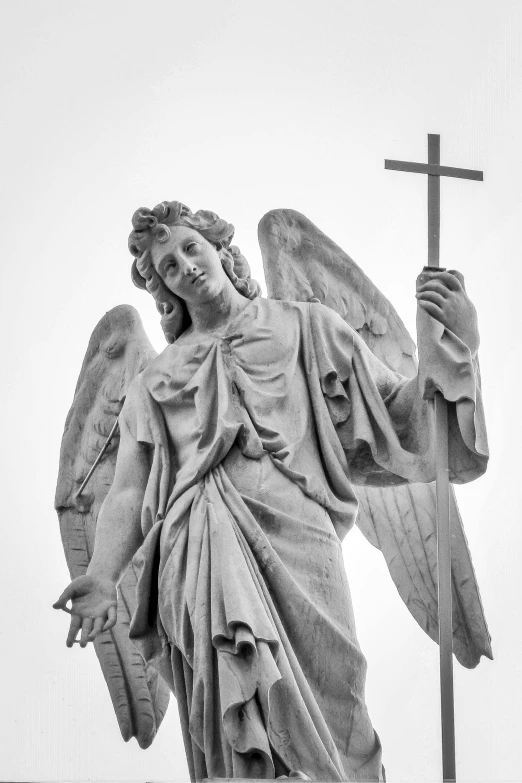 a large statue of an angel with a cross