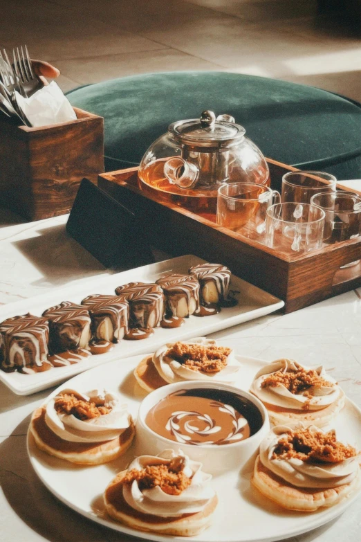 desserts on plate sitting at a table with silverware