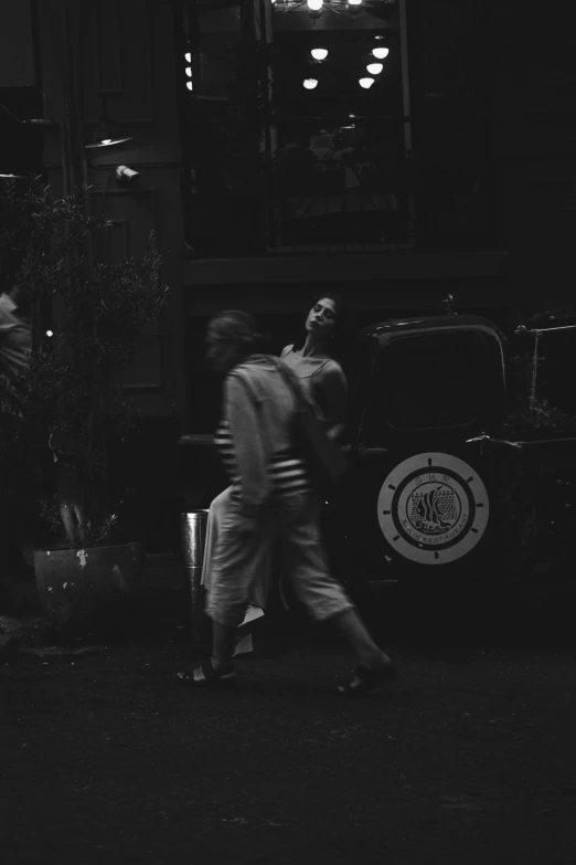 two people walking beside each other on the street