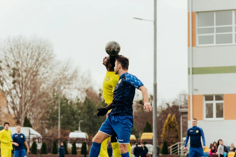 a couple of young men playing a game of soccer