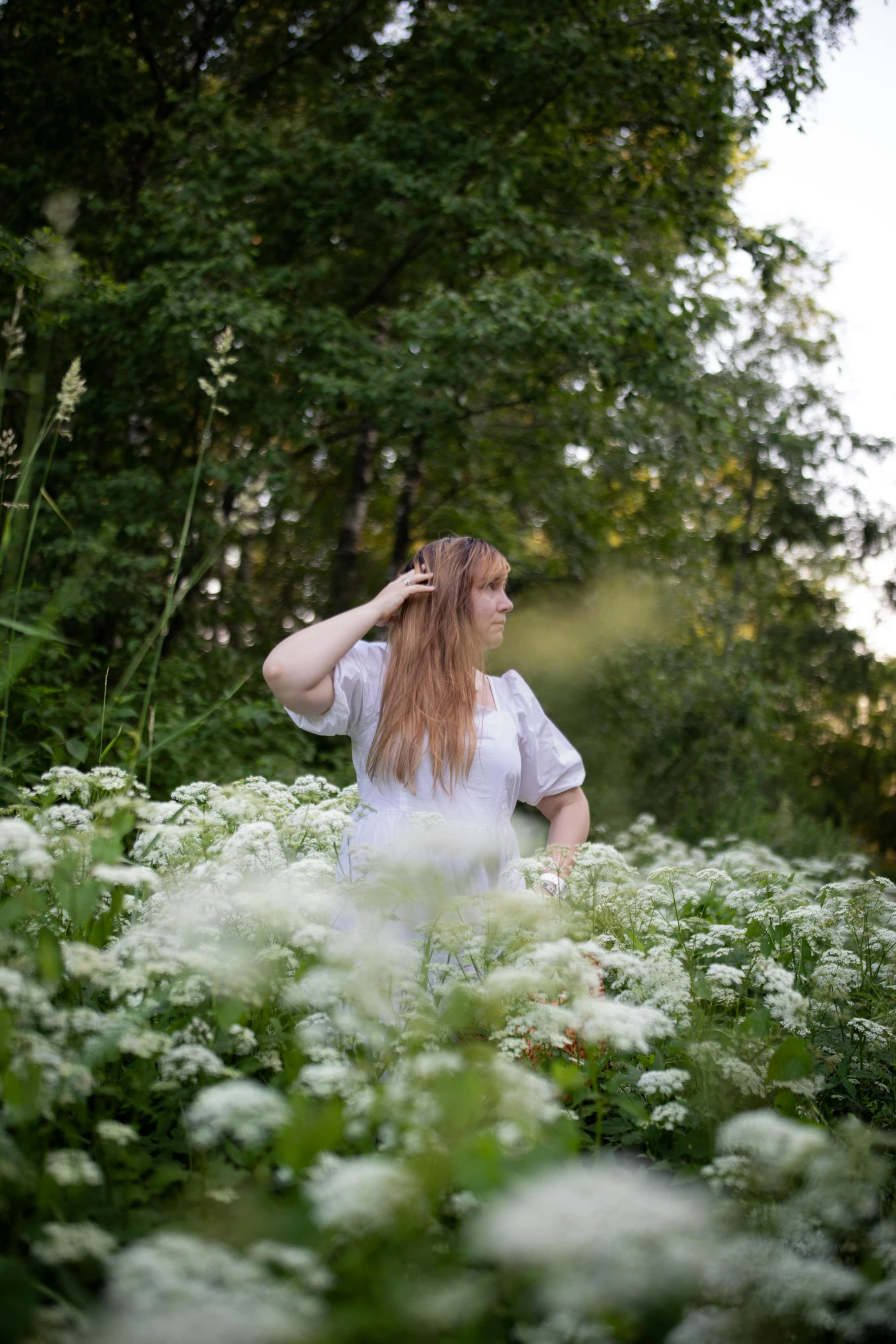 woman in the middle of some pretty flowers in the day