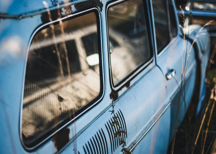 an old car that is sitting on the grass