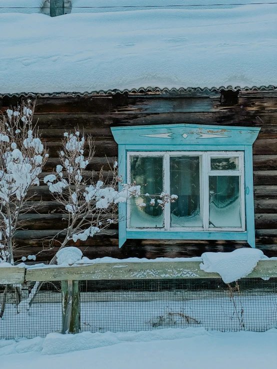 a window sits outside in front of some snow