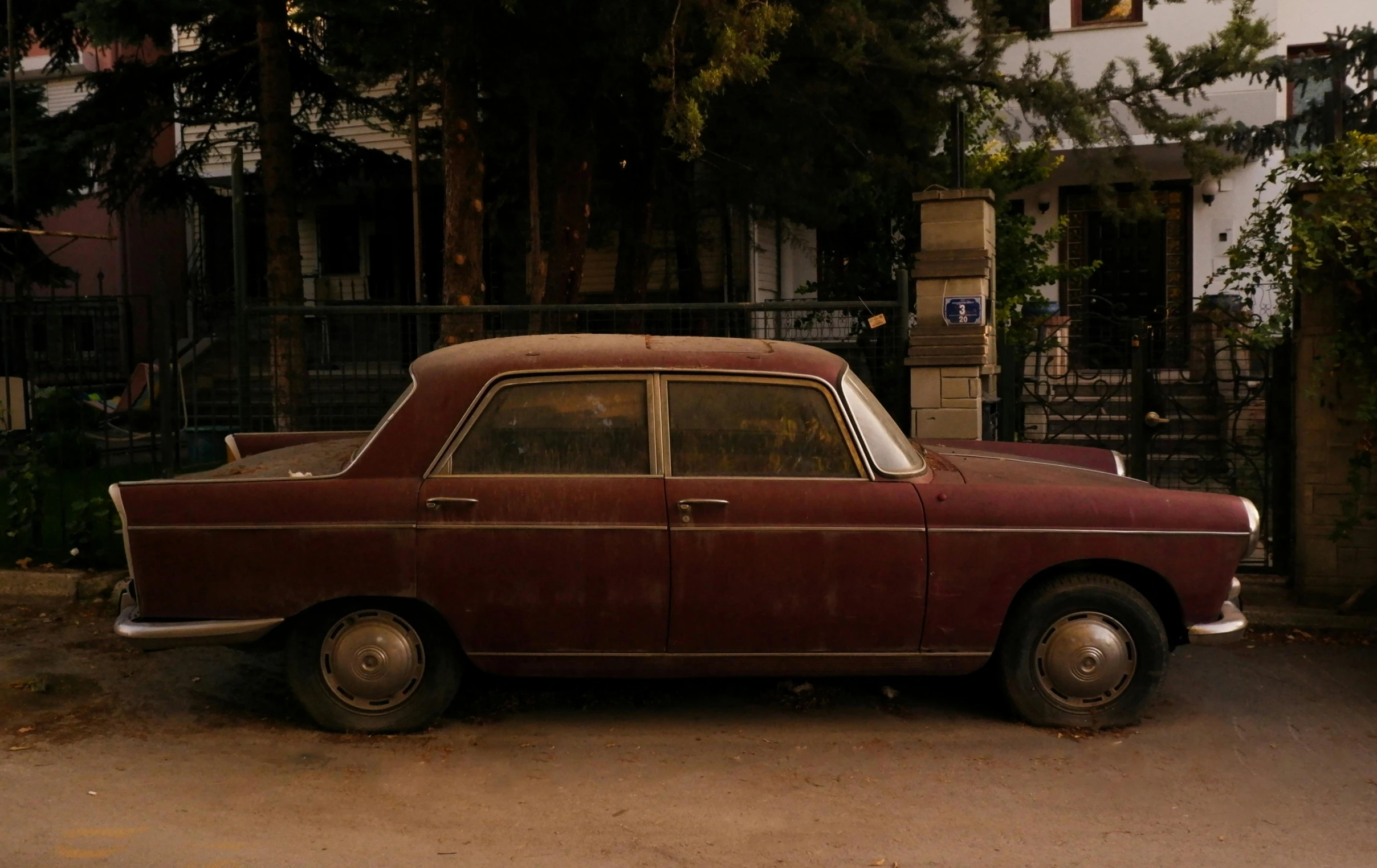 a red car that is sitting on the street