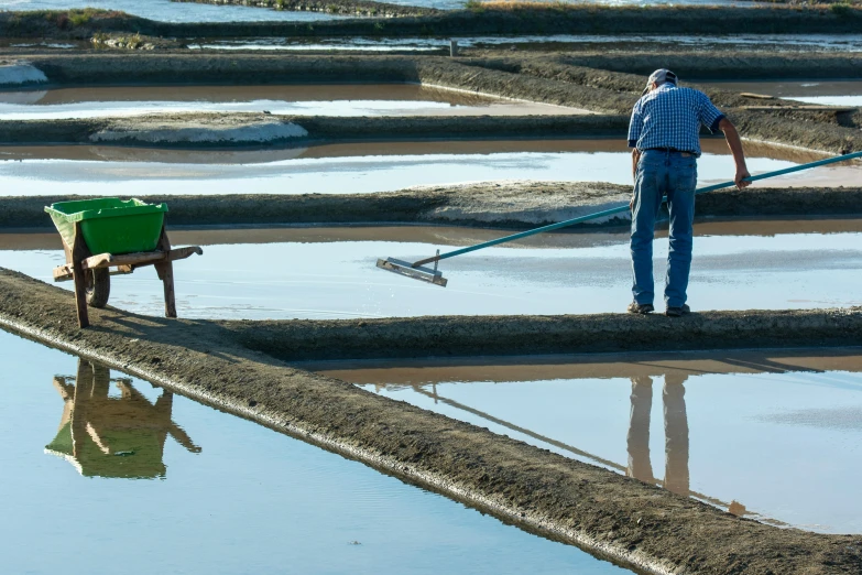 a man standing on a dirty patch of land