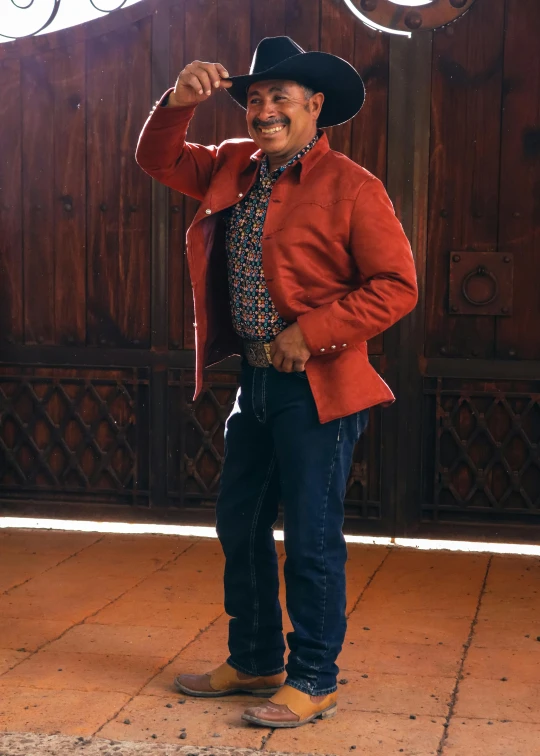 a smiling man wearing a red jacket and hat