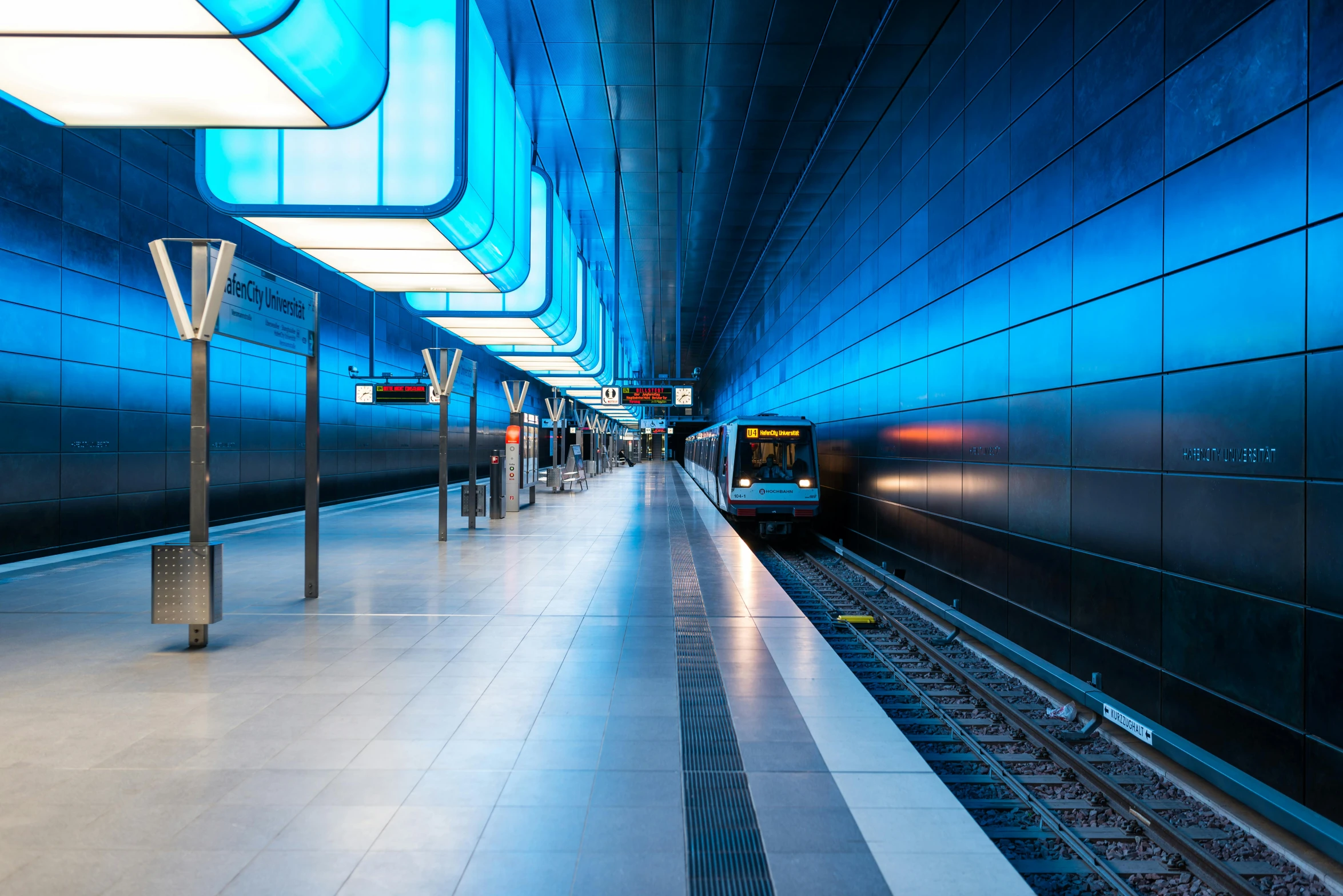 a train sits inside of a tunnel while passengers board