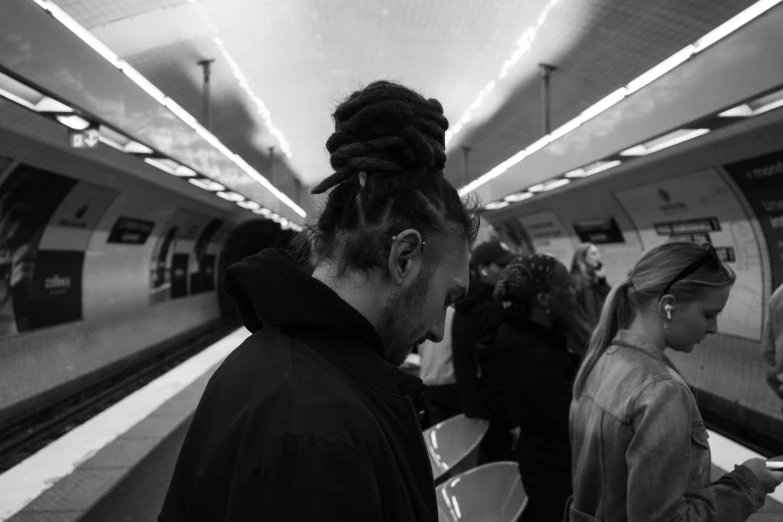 a group of people standing on a train platform