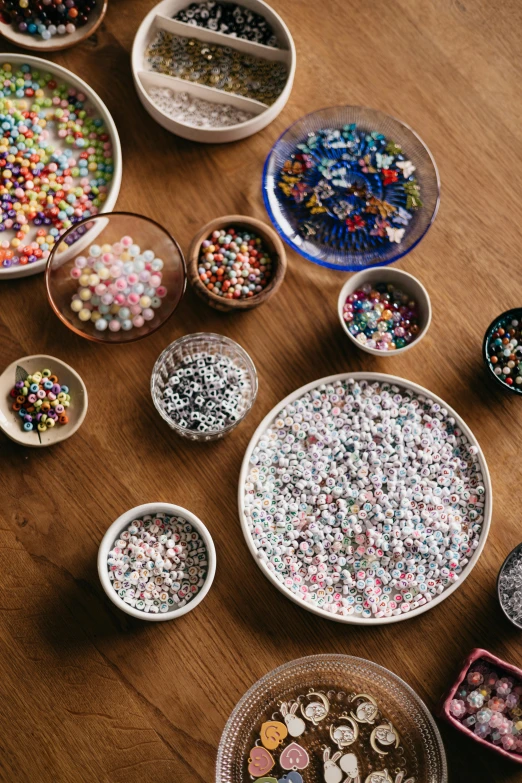 bowls with candy and assorted candies sit on a table