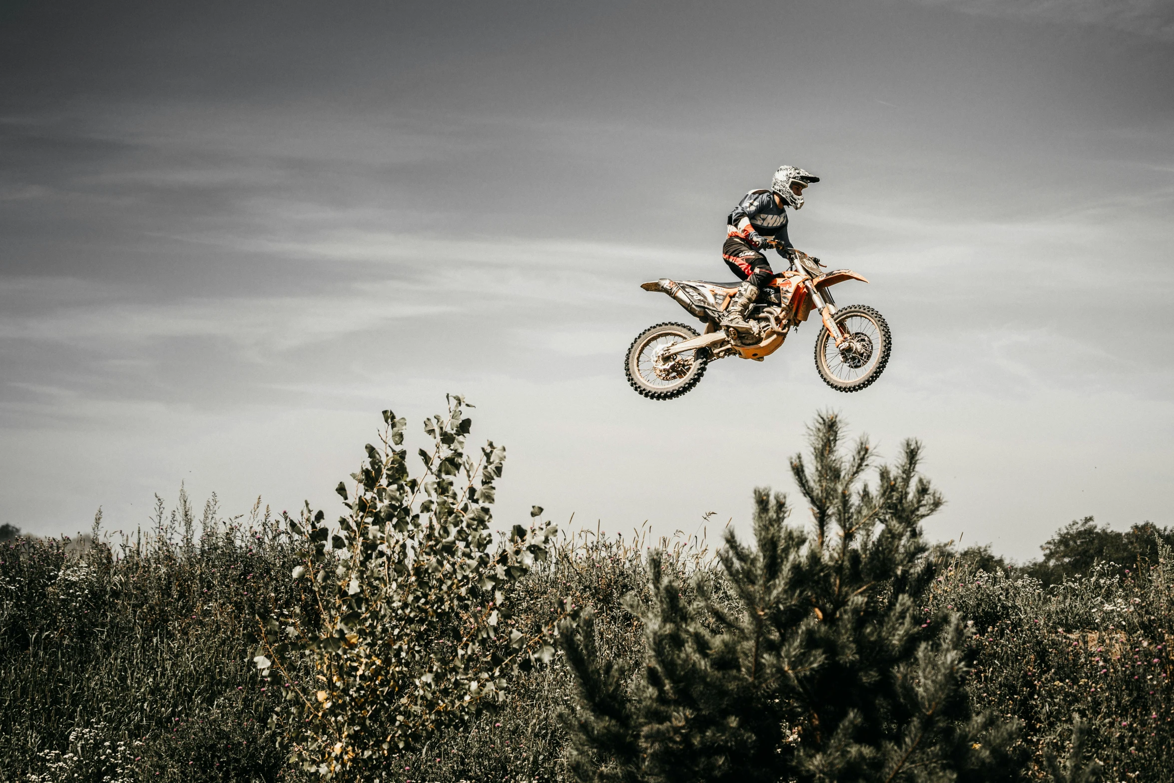 a person jumping a dirt bike through the air