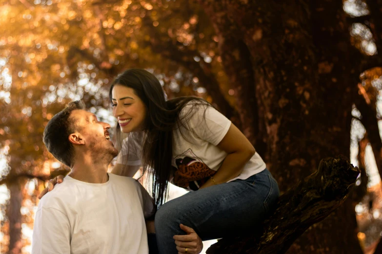 two people in a park with trees in the background