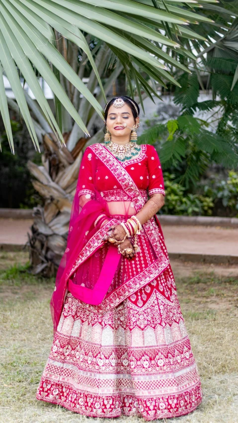 the indian bride in her traditional red and white lehenga
