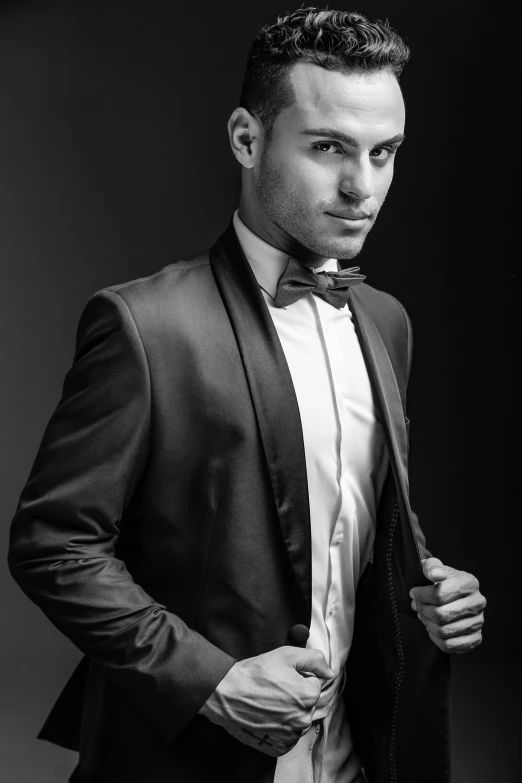 the man wearing a suit is posing in a black and white po