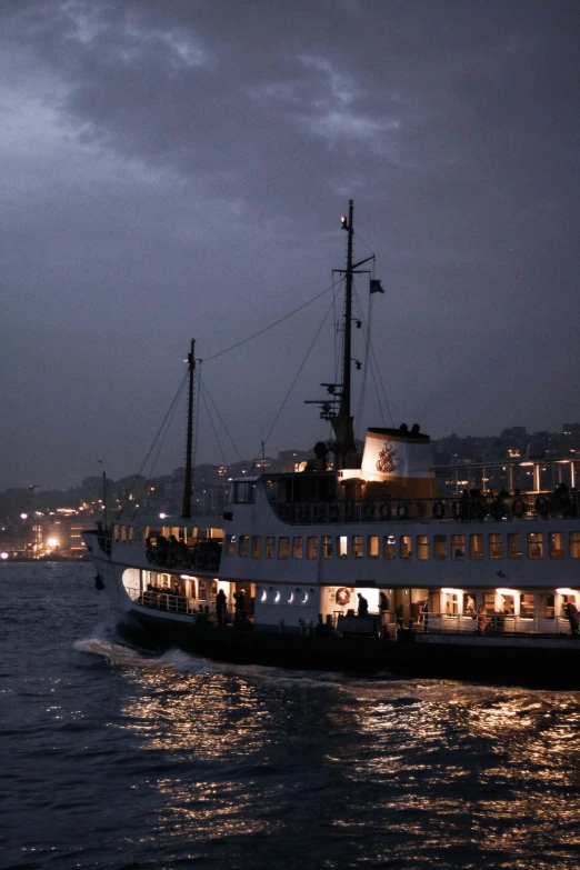 a large boat floating down a river at night