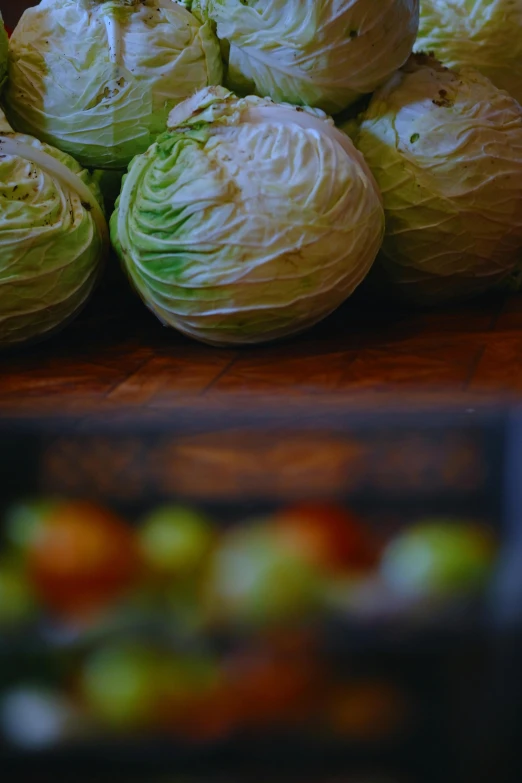 some cabbages are stacked together on a table