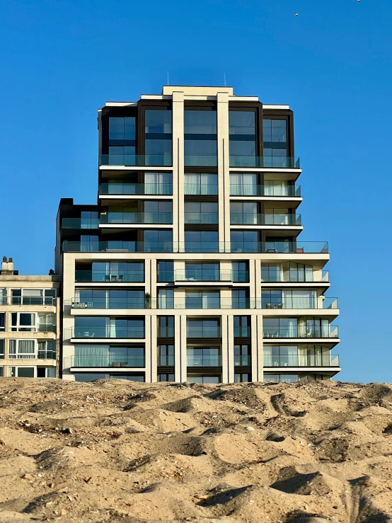 tall building on a hill side in the sand