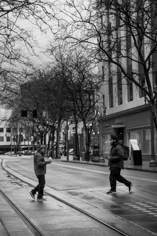 people walking across the wet streets of an old town