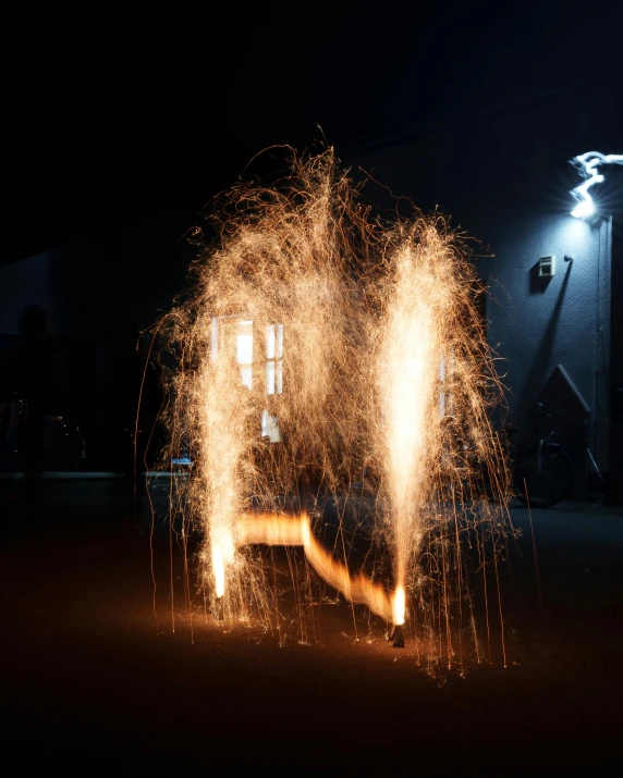 firework with bright white and orange flames on a dark background