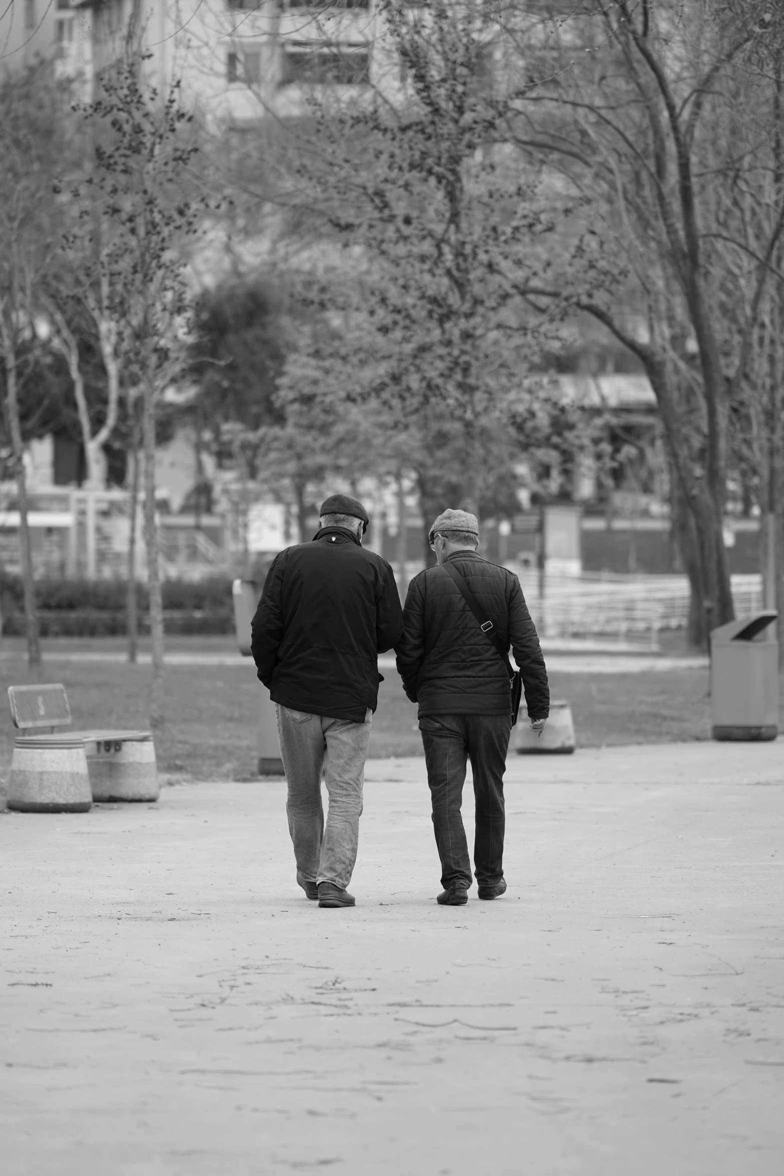 two people walking down the sidewalk holding hands