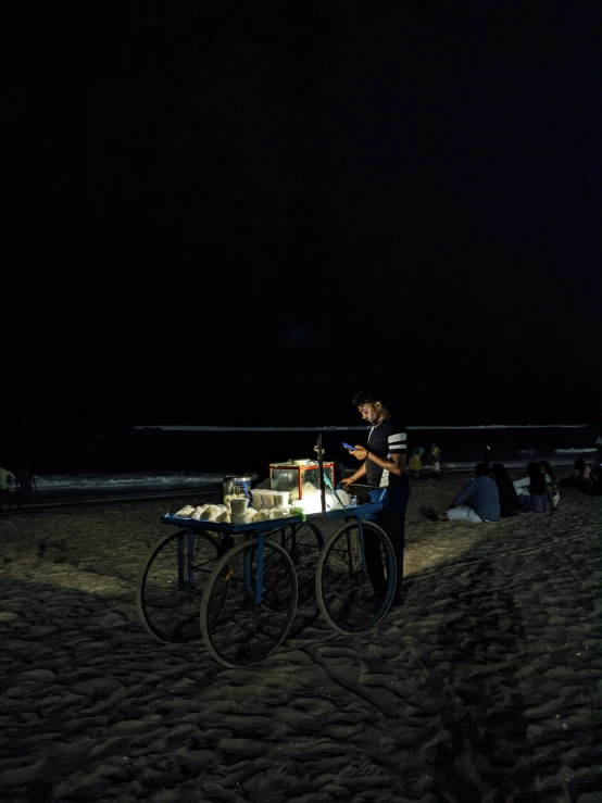 a woman sitting at a table made out of three large old wheel spokes