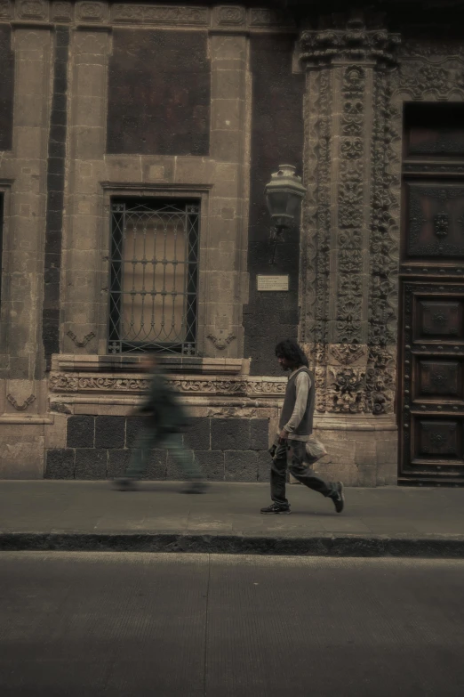 a person is walking down a street in front of an old building