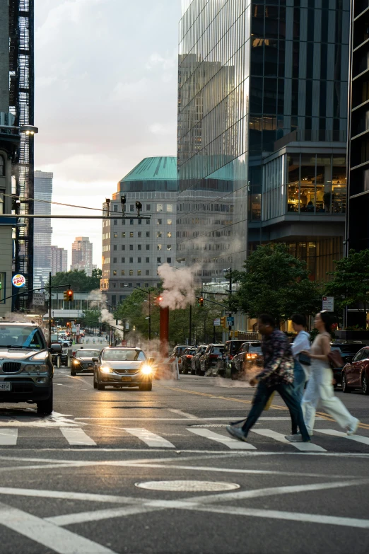 people are walking and crossing an intersection in the city