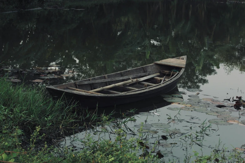 a row boat floating in the water on a lake