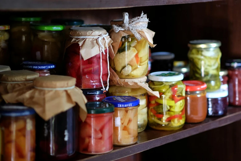 several jars of pickles on the shelf