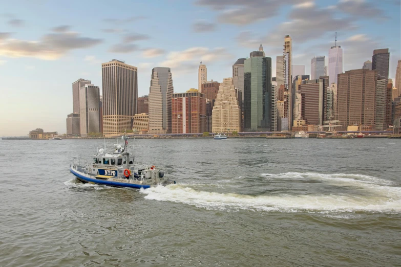 a boat sailing by in front of a large city