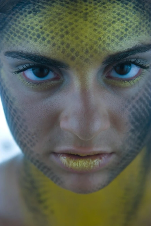 a man with a yellow freckly cover over his face