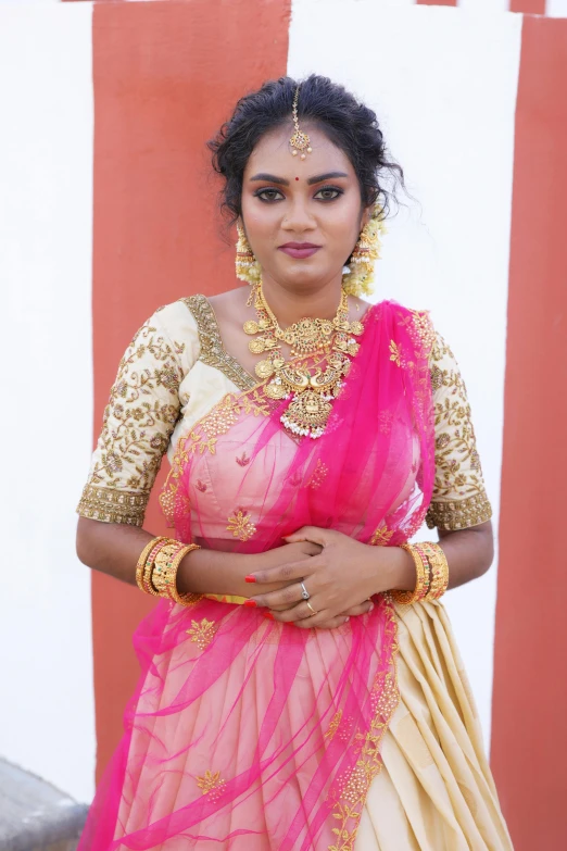 woman wearing a pink and yellow sari