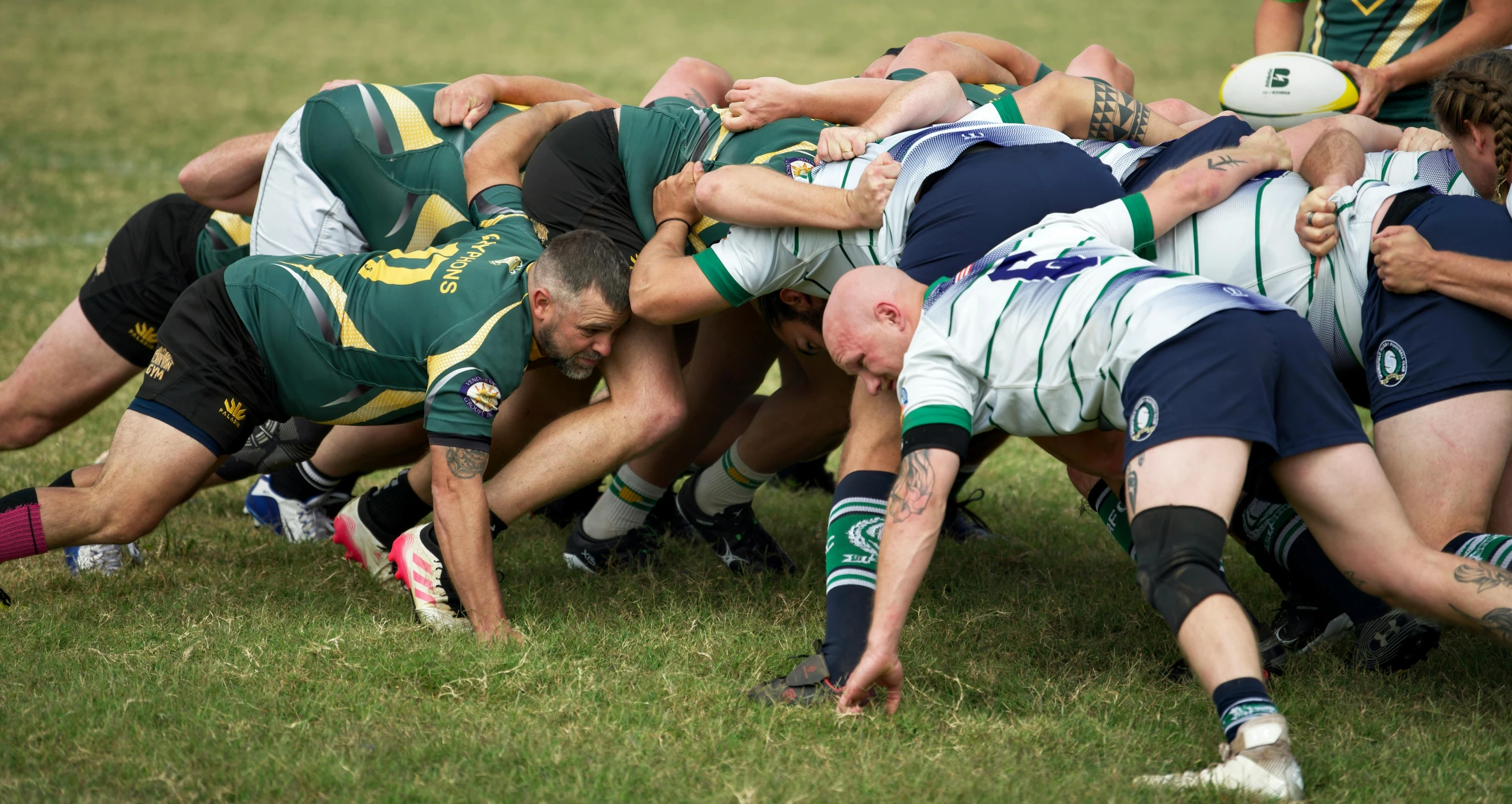 several men in uniforms are playing a game of rugby