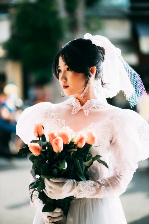 a woman dressed in a dress holds roses