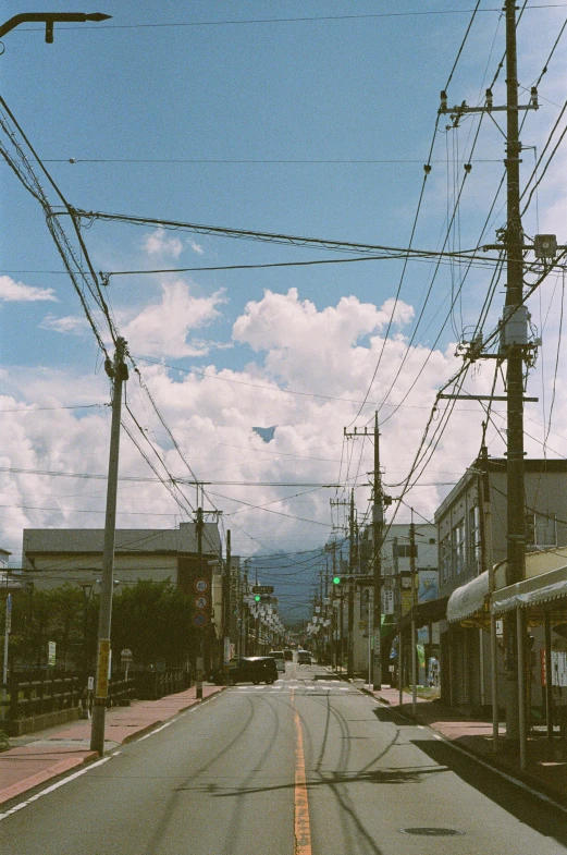 an empty street with electrical lines above and below