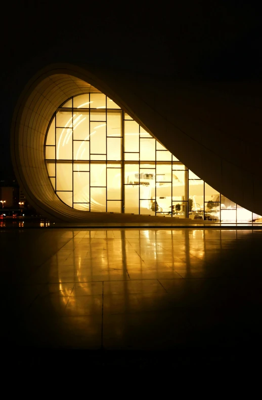 a very large building that is lit up by the window