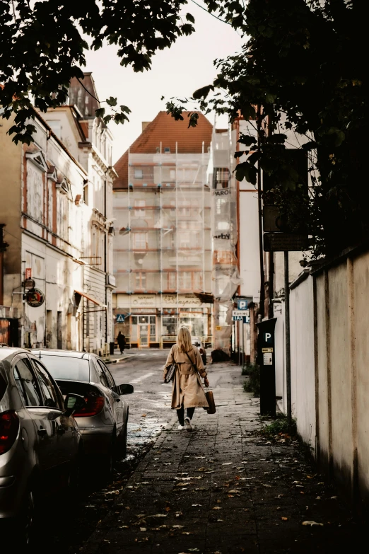 an old woman is walking down the street in town