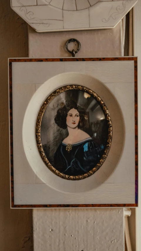 a close up of a plate with a lady in a blue dress