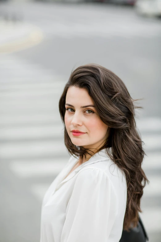 an attractive woman in white shirt posing for the camera