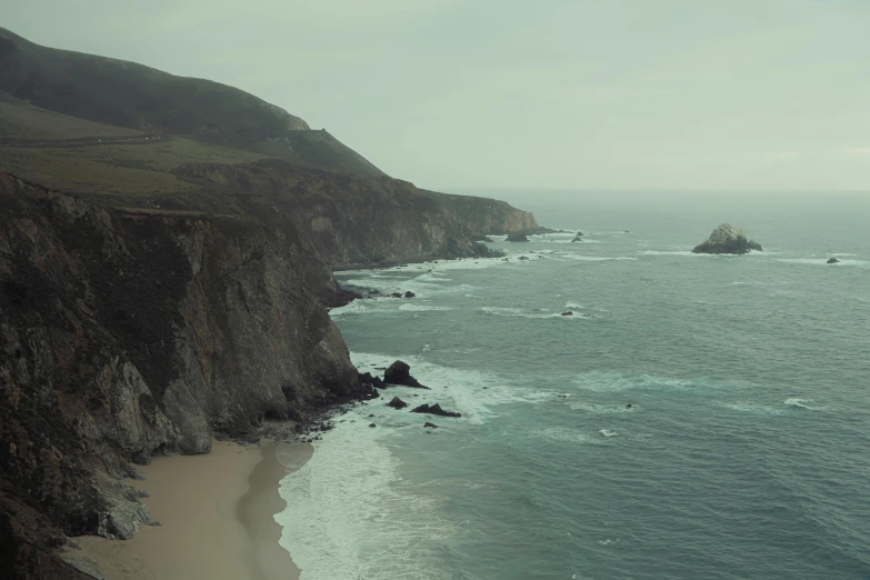 a picture taken from a high above looking at the ocean and a rocky coastline