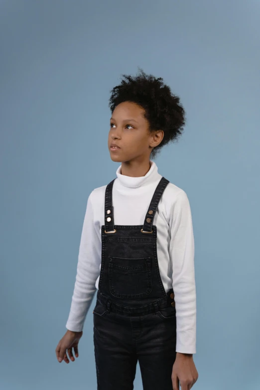 a person wearing an apron with a sweater and suspenders