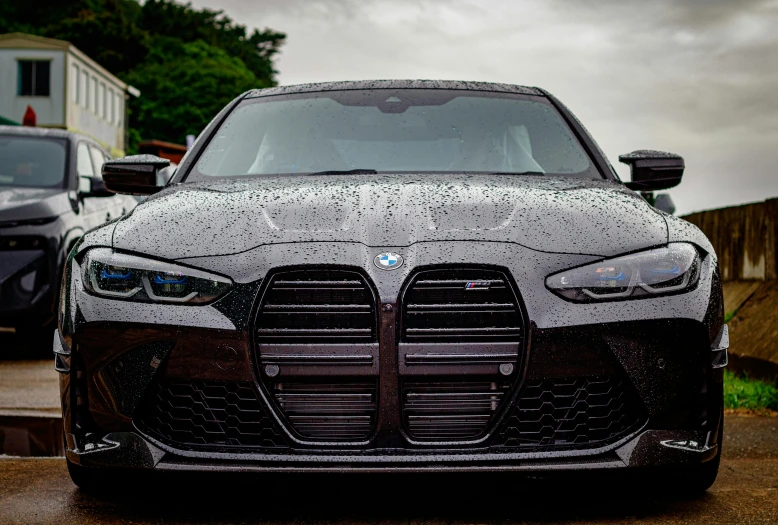 an image of a black sports car parked in the driveway