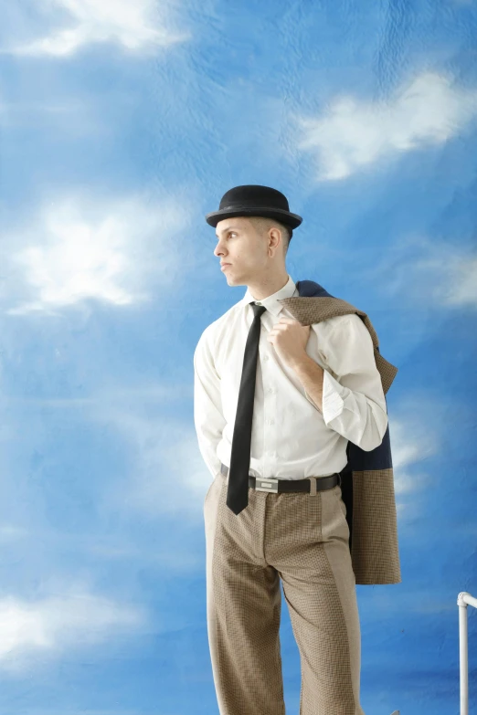 there is a man dressed in an old - fashioned suit and hat and holding a backpack while standing up