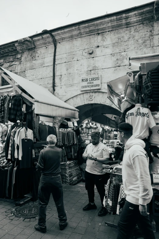 there are people walking through an old market